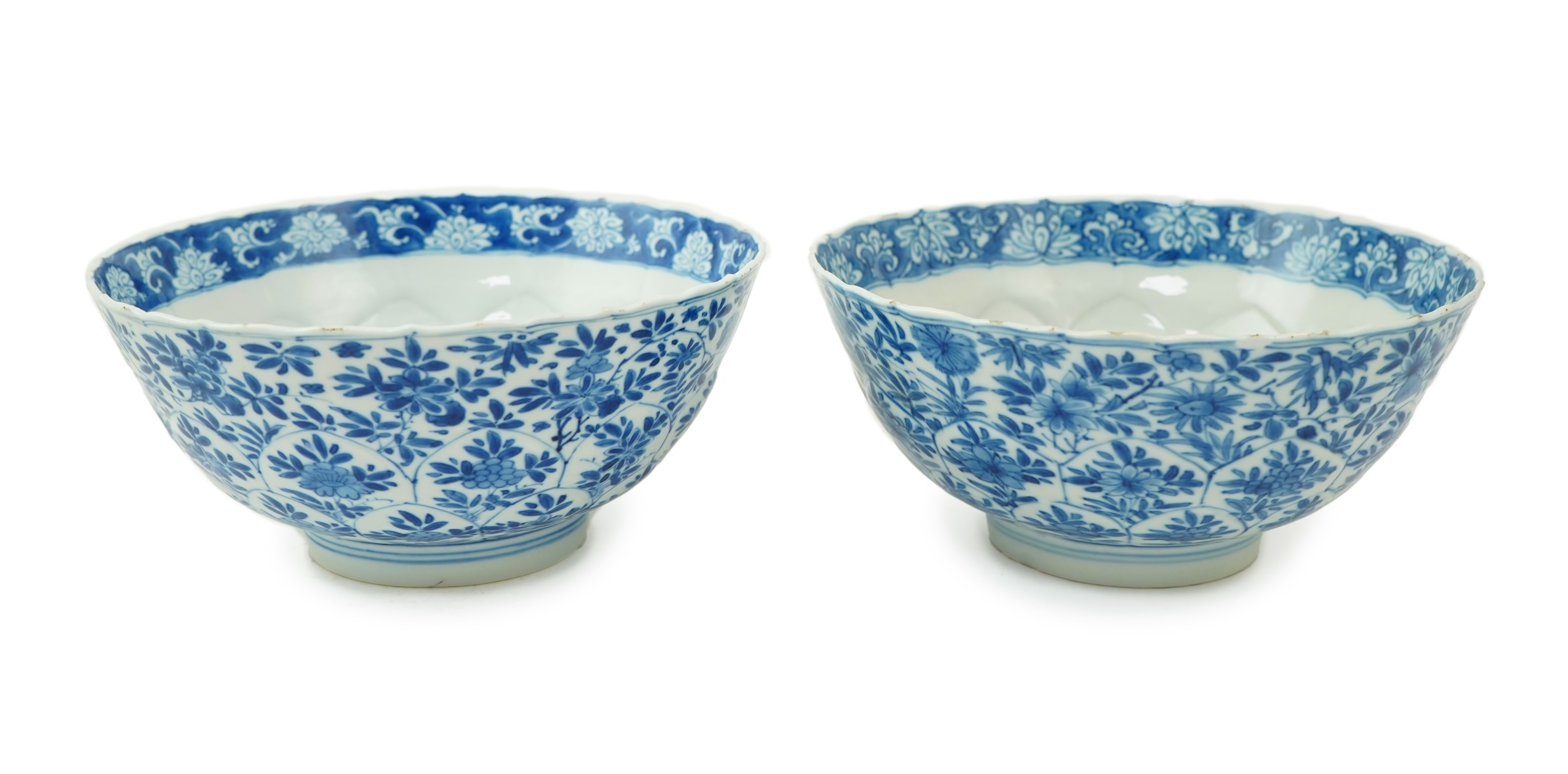 A near pair of Chinese blue and white lotus flower moulded bowls, Kangxi period